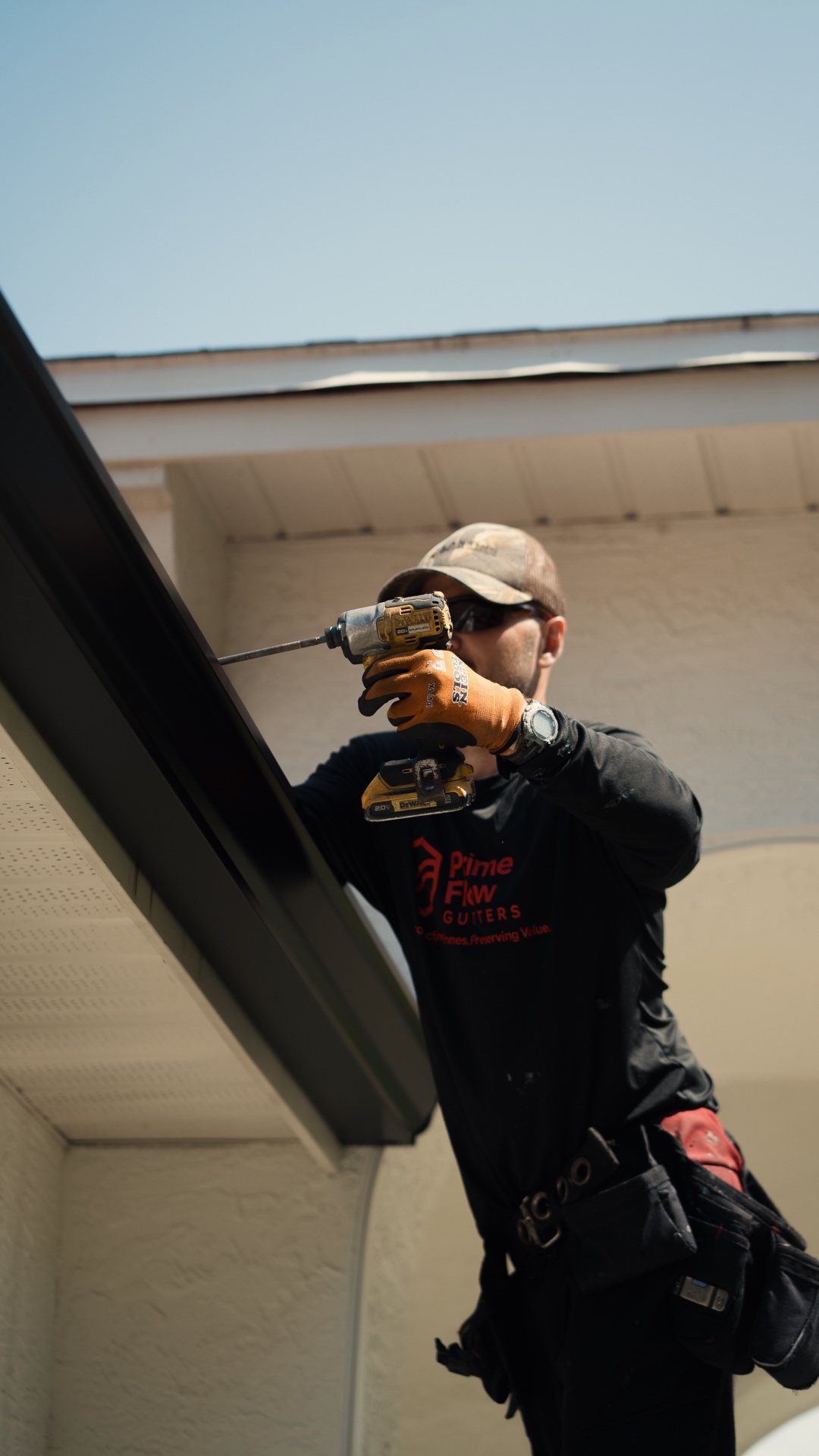 PrimeFlow installer fastening a gutter along a Florida roofline